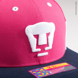 Close up shot of the embroidered club logo on the Pumas Truitt Snapback hat.